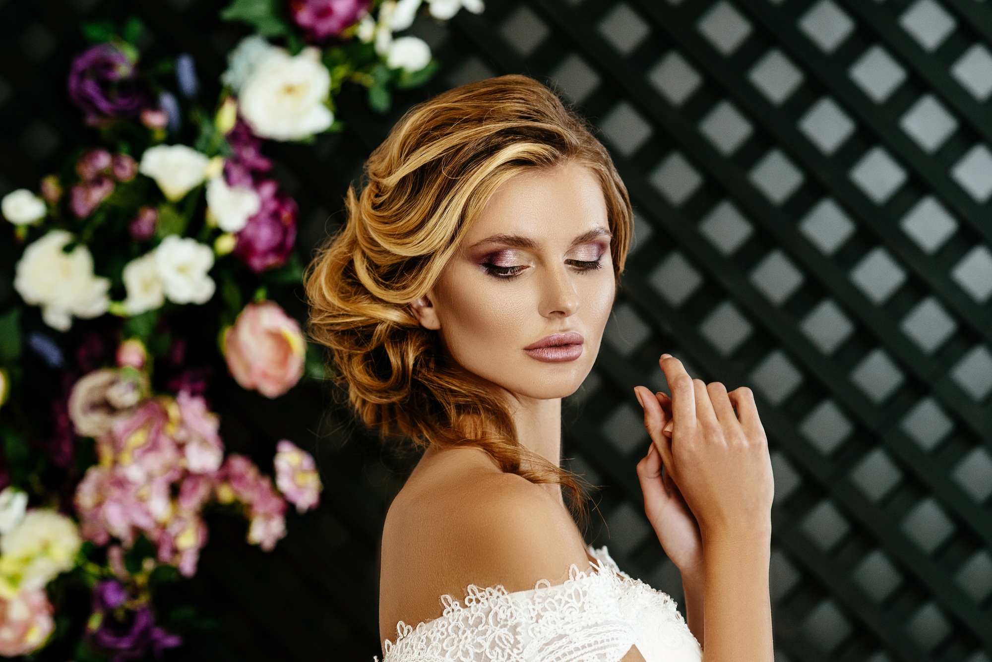 beautiful sexy blonde bride.posing in wedding dress on wedding flower arch