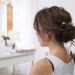 Hairdresser creating a hairstyle for bride in salon