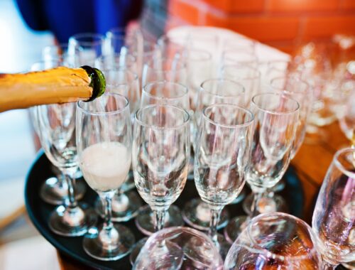 Pour champagne into glasses at wedding party
