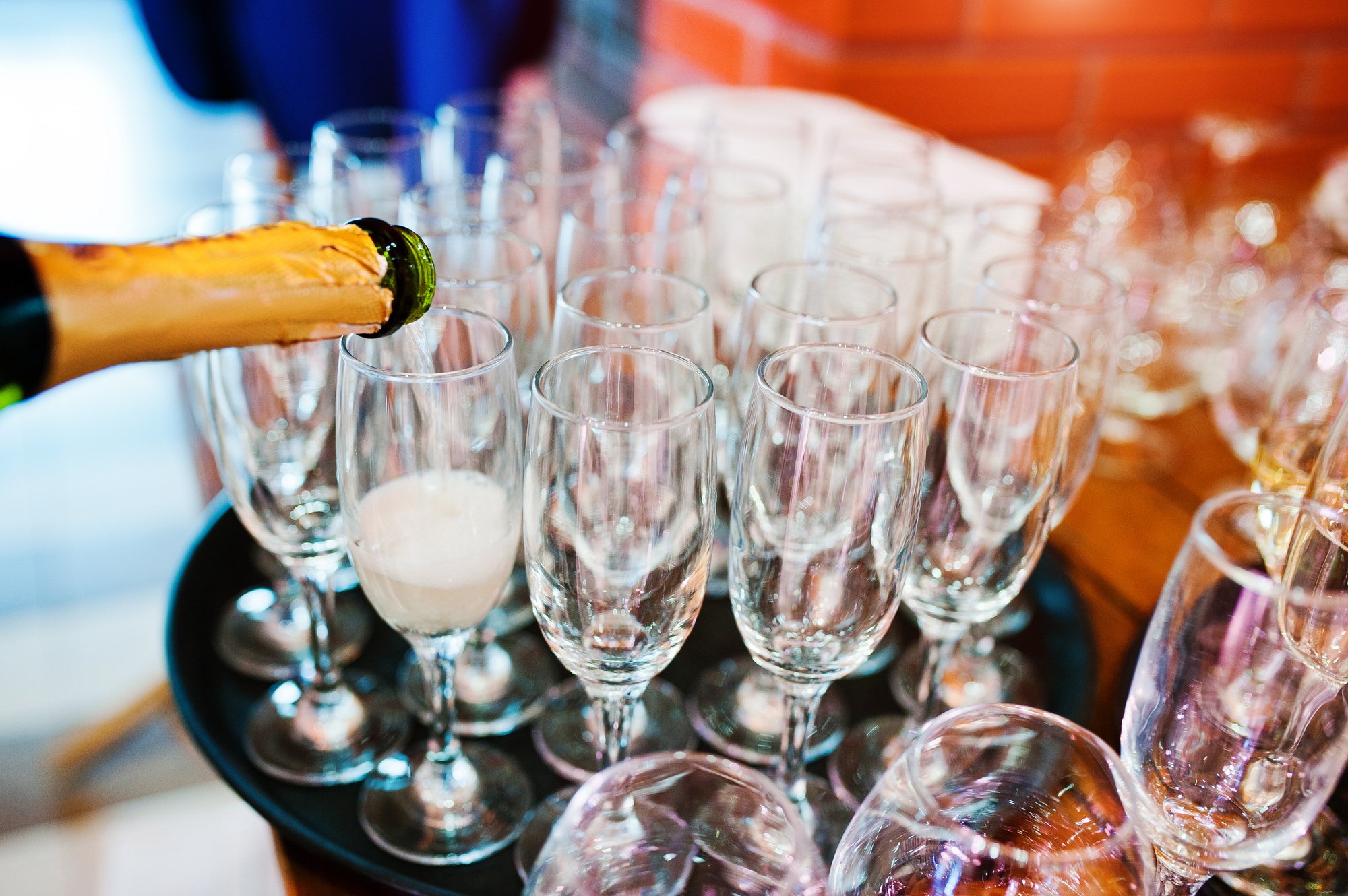 Pour champagne into glasses at wedding party